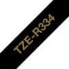 Textilband TZe-R334 nicht klebend gold auf schwarz 12mm x 4m Brother Textilband TZe-R254 mit goldener Schrift auf weißem Hintergrund und einer Breite von 24 Millimeter, sowie 4 Meter Länge.